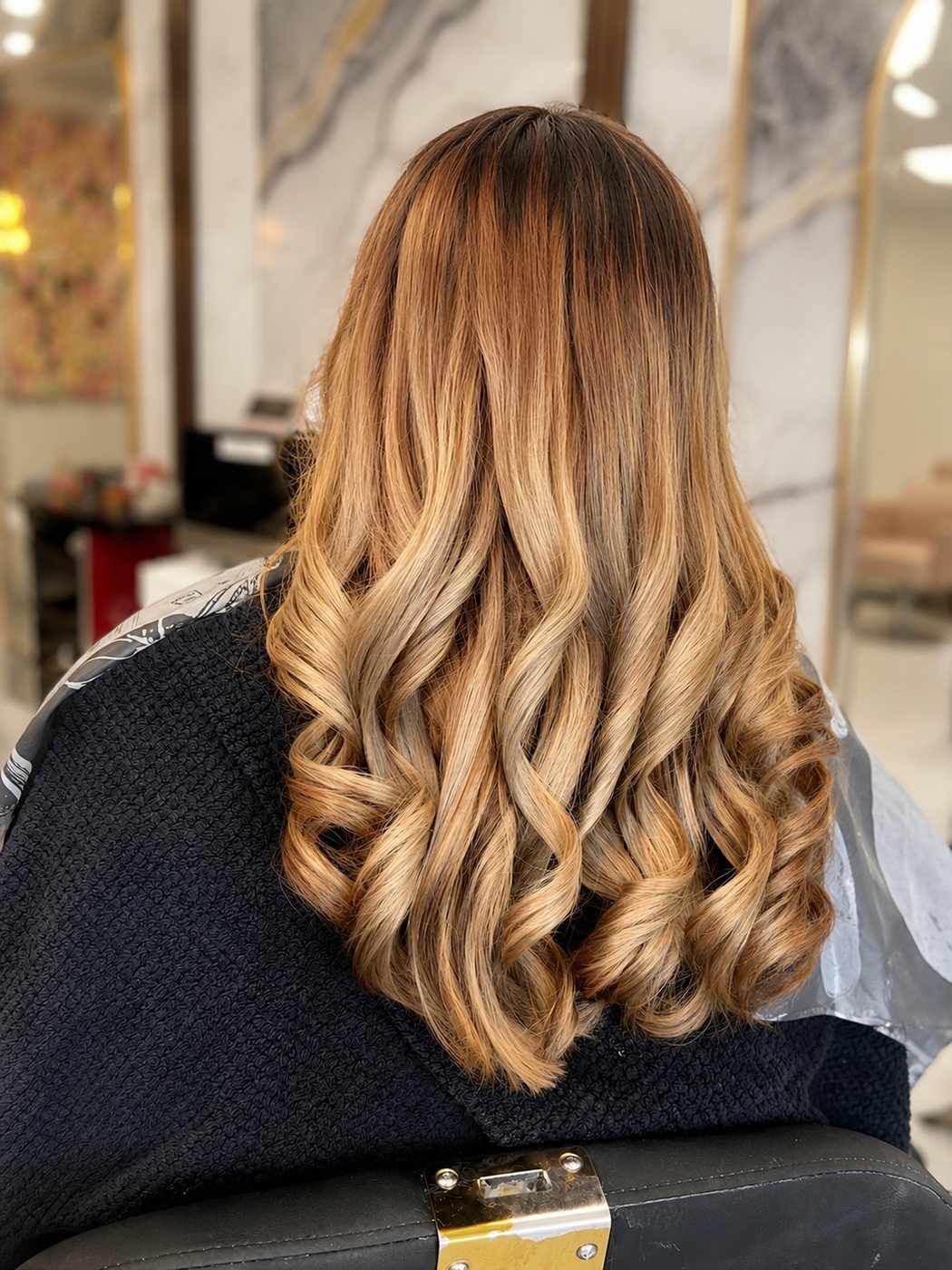 After: warm caramel balayage with soft curls by Gurbina