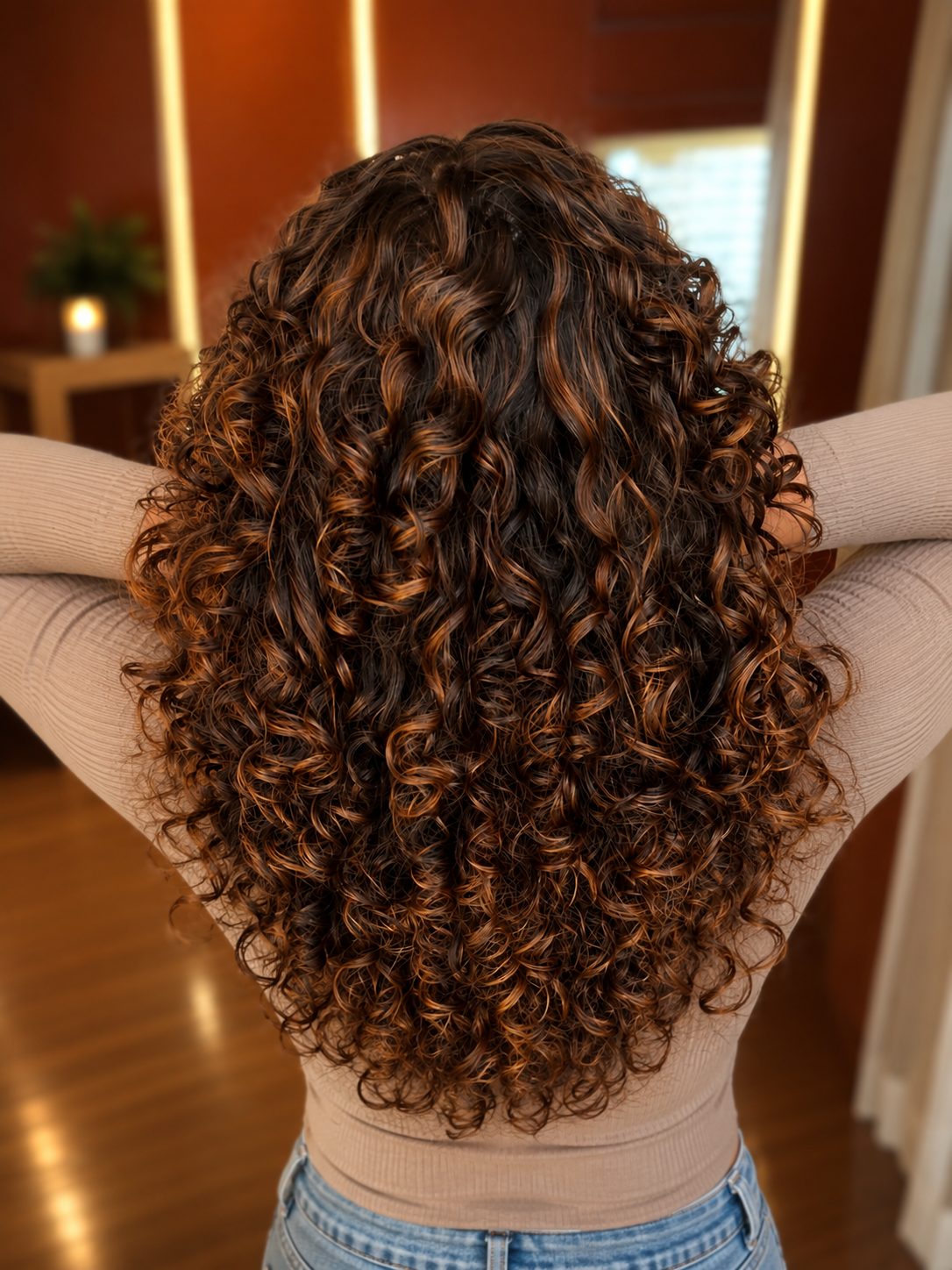 Copper balayage glowing through natural curls