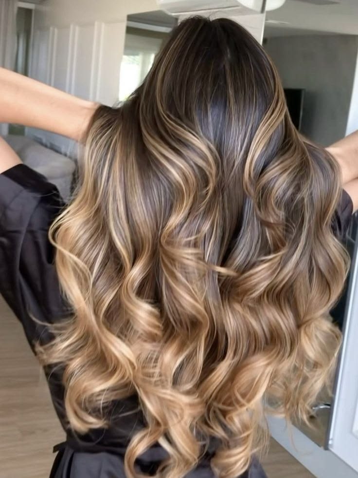 Golden blonde balayage with bouncy curled ends