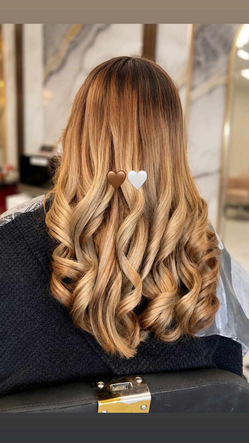 Honey balayage melt on dark hair with bouncy curls